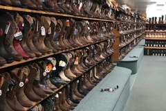 A large shelf of western boots.